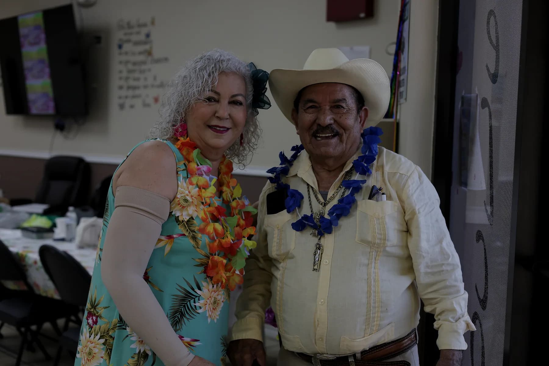 Two participants smiling together during a celebration at the center