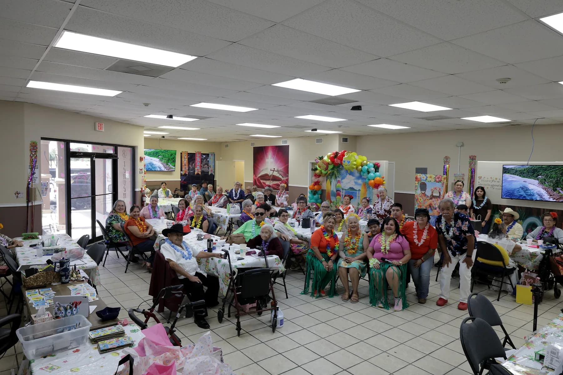 Participants and staff at Amor Y Vida Adult Day Care gathered together in the main activity room